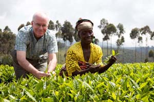 Brennan O'Donnell is taught how to pick tea during a visit to Busekera Village.